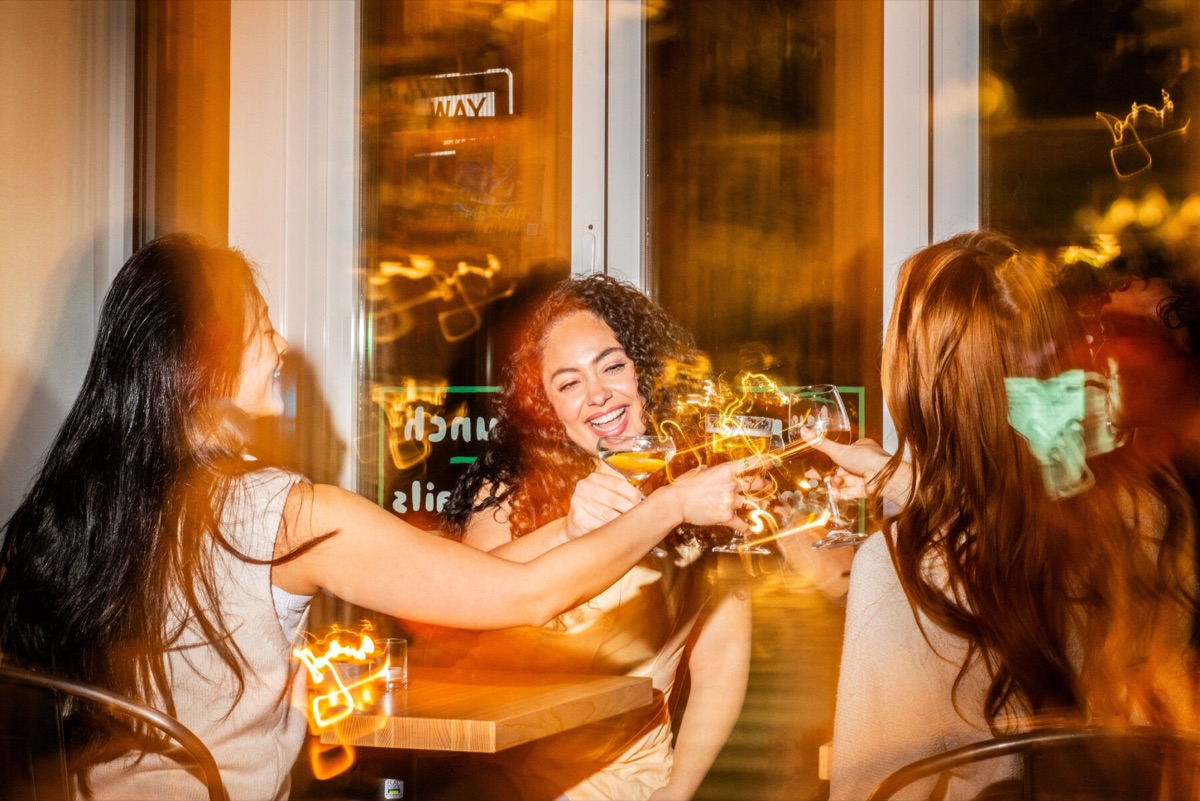 Guests toasting at a window table inside Westville, New York